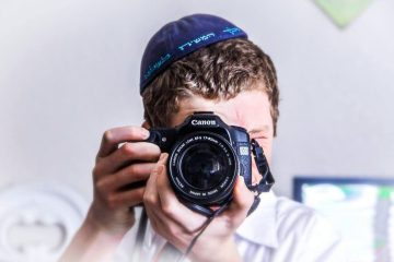 A boy clicking a picture with a camera