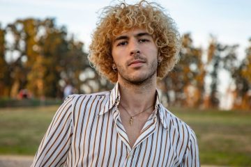 Blonde hair man wearing gold jewellery