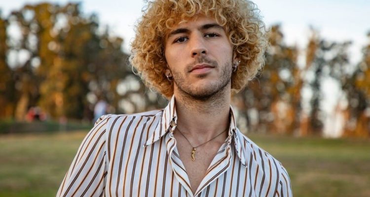 Blonde hair man wearing gold jewellery