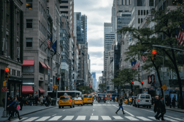A busy New York City street with heavy traffic and skyscrapers