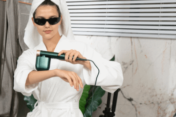 Woman removing hair wearing white robe