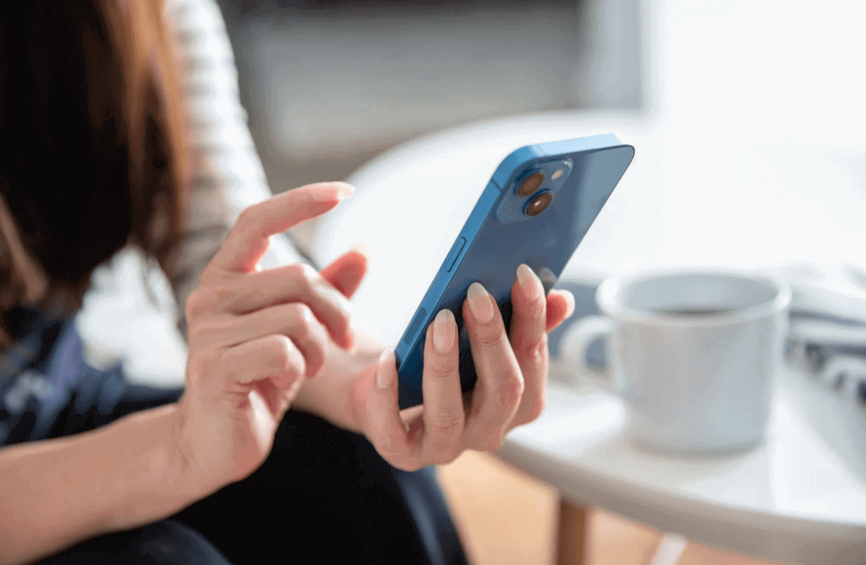 Woman holding cell phone with clear iPhone case