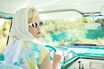 Woman in hijab driving a vintage car
