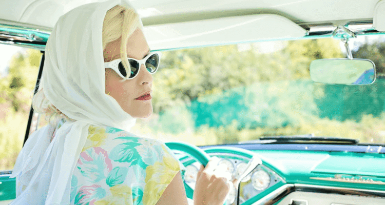 Woman in hijab driving a vintage car