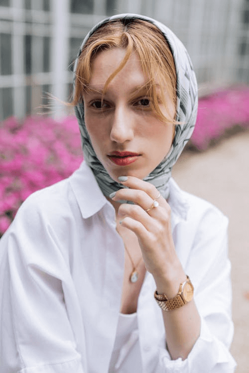 Woman in white shirt with headscarf creating vintage style