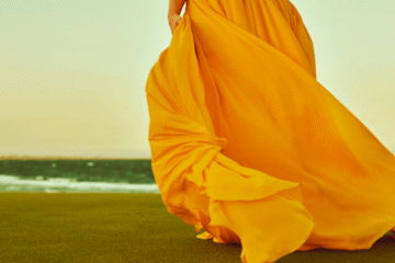 Woman in yellow dress standing on grass highlighting color choice