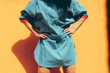 Woman standing against yellow wall reflecting balanced personal style